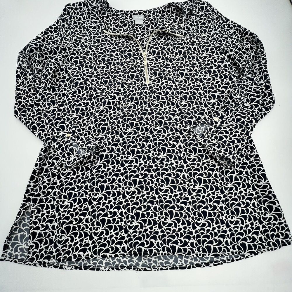 Chico’s black and white blouse with front zipper closure. Size Medium